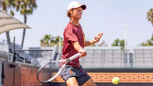 Niels Hoffmann hits a return on tennis court