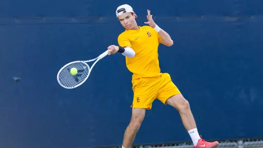 Matteo Morazzi hits a forehand on court wearing all yellow.