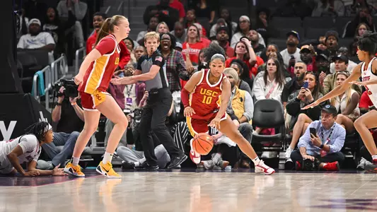 Malia Samuels dribbles basketball down court