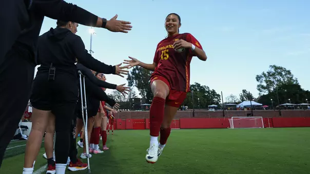 Maribel Flores gives her teammates a high five as she runs out during introductions at Rawlinson Stadium.
