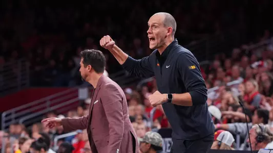 USC women's volleyball associate head coach Spencer McLachlin cheers from the sideline during a match at Galen Center