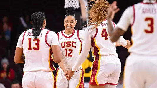 Rayah Marshall and Kiki Iriafen congratulate JuJu Watkins during USC's win over CBU