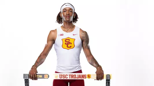 Johnny Brackins Jr. posed behind hurdle
