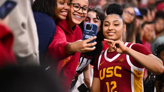 JuJu Watkins poses with fans after USC's win over rival UCLA at Galen Center