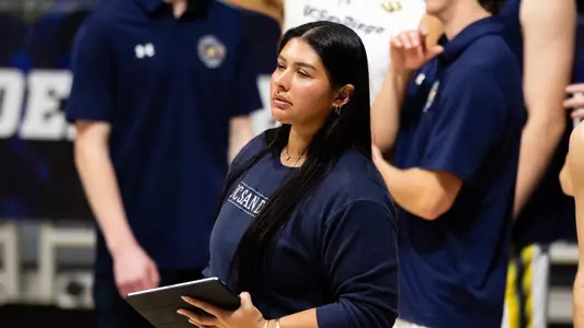 USC women's volleyball assistant coach Blossom Sato stands on the sidelines at her previous position with the UCSD men's team.