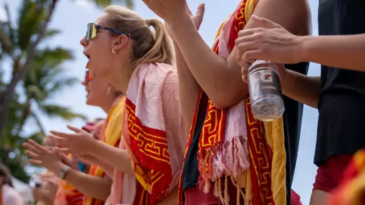 USC beach volleyball sophomore Jess Horwath cheers on the team during a match at the Outrigger Duke Kahanamoku Beach Classic in Honolulu, Hawai;'i.