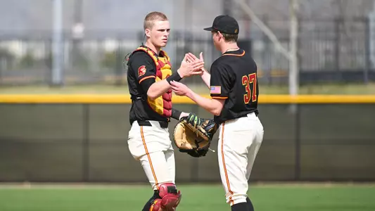 John Elliott, Jackson Baker shake hands after a win against George Washington.
