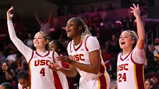 Rian Forestier, Clarice Akunwafo and Brooklyn Shamblin celebrate a USC 3-pointer made at Galen Center.
