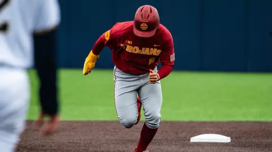 Designated hitter, Kevin Takeuchi, sprints toward the next base during the team's third game against Michigan.