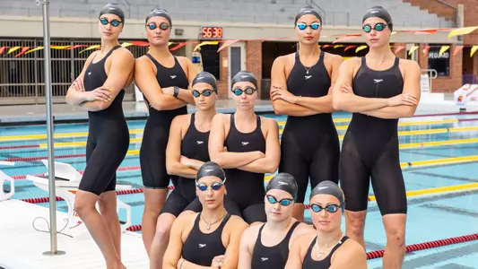 USC's NCAA's qualified swimmers pose for team photo in cap and goggles and swimsuit.