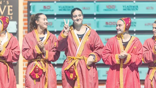 Alma Yaacobi shows Fight On during player introductions at Uytengsu Aquatics Center.