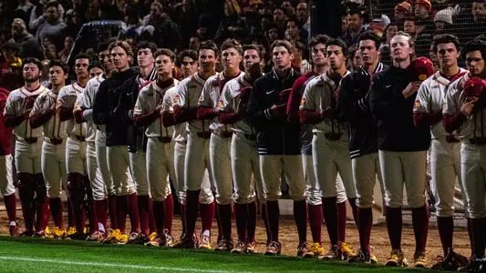 The USC baseball team stands at attention during the national anthem before a home game against Oregon.