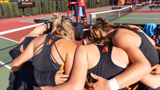USC women's tennis team gathers for a huddle after a match.