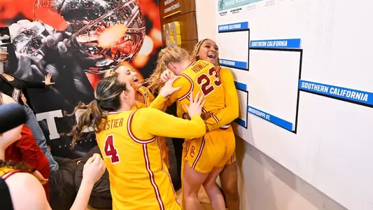 Kiki Iriafen embraces Avery Howell in the locker room after USC earns a spot in the Sweet 16