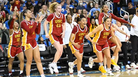 USC players celebrate from the bench in the Trojans' win at UCLA to claim the Big Ten regular-season title.