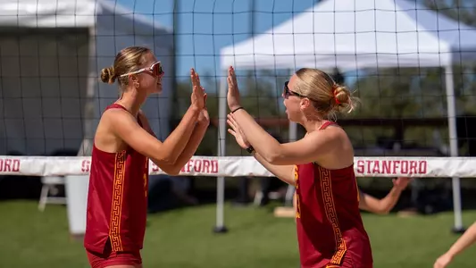 USC beach volleyball junior Delaney Karl and graduate Ella Larkin high five during a match against Oregon at the MPSF Midseason Rumble in Stanford, Calif,