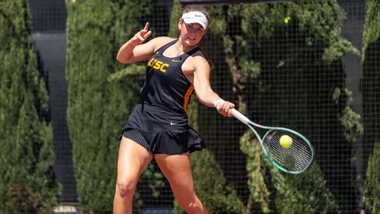 Lily Fairclough returns a ball on the tennis court.
