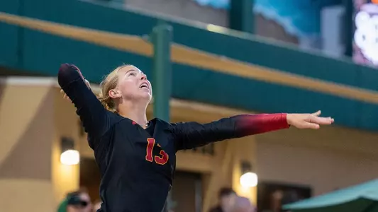 USC beach volleyball graduate Ella Larkin tosses a ball to serve during a match against Cal Poly in the Center of Effort Challenge at the Swanson Beach Volleyball Complex in San Luis Obispo, Calif.