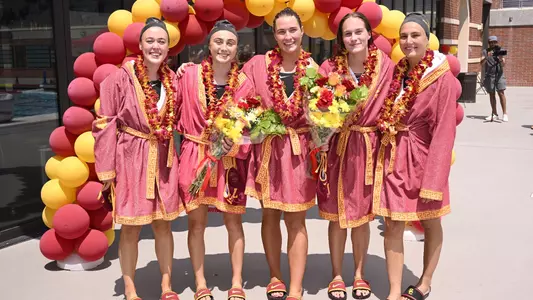 USC seniors pose on the pool deck for Senior Day