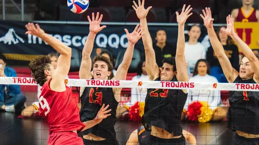 USC men's volleyball players Christian Connell, Guy Genis, and Dillon Klein go up to block an attack by a Stanford player during a match at Galen Center.