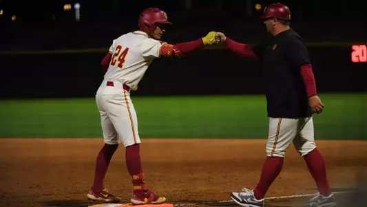 Augie Lopez fist bumps the first base coach after hitting an RBI single.