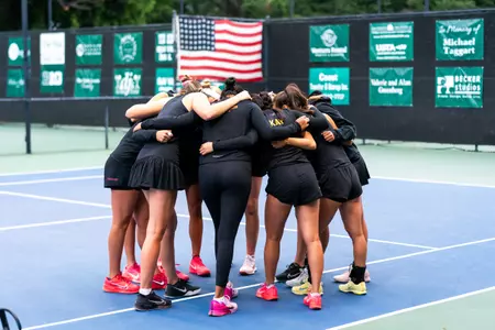 The Trojans gather on center court for a team chant.