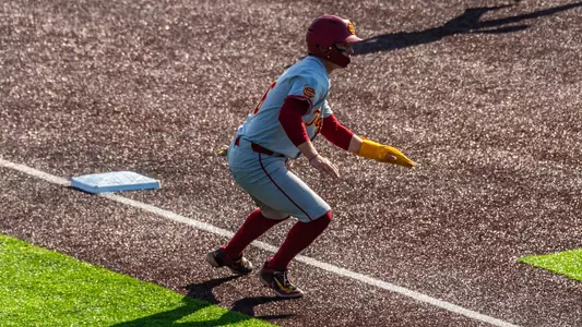 Brayden Dowd rounds the base and stops at third.