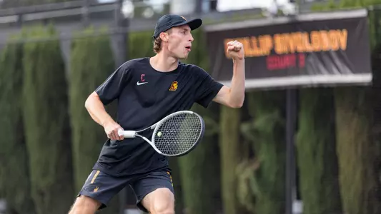 Graduate Student Tristan Bradley celebrates after scoring a point in doubles against UCLA