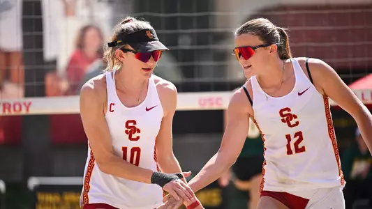 USC beach volleyball All-Americans Madison White and Zoey Henson slap a high five during a match