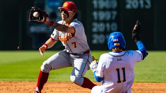 Abbrie Covarrubias catches a ball at second base while a UCLA player slides in.