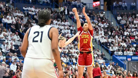 JuJu Watkins shoots over UConn defenders in USC's win over the Huskies in Hartford, Conn.