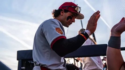 Abbrie Covarrubias high fives a teammate coming into the dugout.