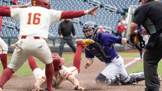Ethan Hedges slides in safely at home plate to win it against Washington at the Big Ten Tournament.