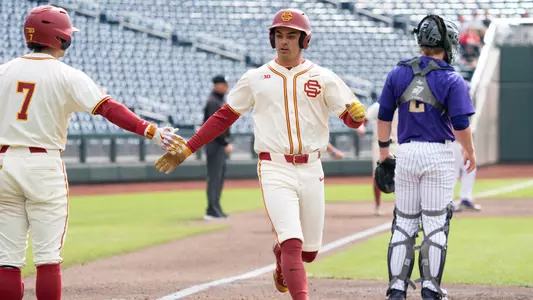 Augie Lopez scores a run during the Trojans game against Washington in the Big Ten Tournament.