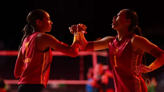 USC women's volleyball redshirt junior outside hitter Adonia Faumuina and redshirt sophomore middle blocker Leah Ford greet each other during starting lineup introductions at Galen Center.