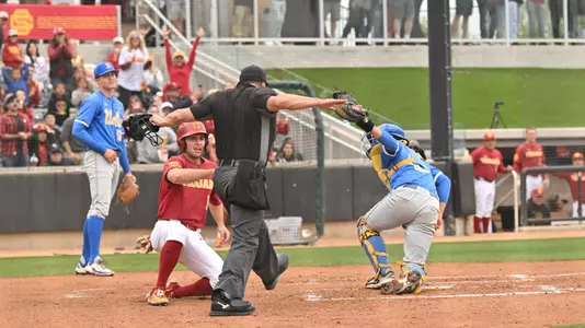 Jack Basseer slides safely past the tag to score at home in the bottom of the second inning during Game 2 against UCLA.