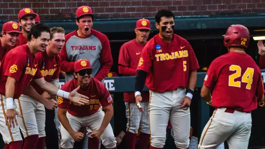 The Trojans celebrate as Augie Lopez returns to the dugout after hitting a home run in the NCAA Regionals game against Saint Mary’s.
