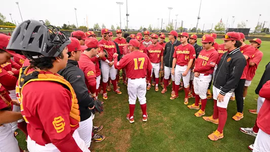 The USC baseball team huddles with Head Coach Andy Stankiewicz in the middle to talk postgame after a victory over UCLA.