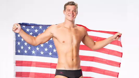 Charlie Mills holds the USA flag during a photo shoot