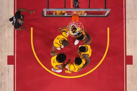 Photo of USC Men's Basketball huddling during a game