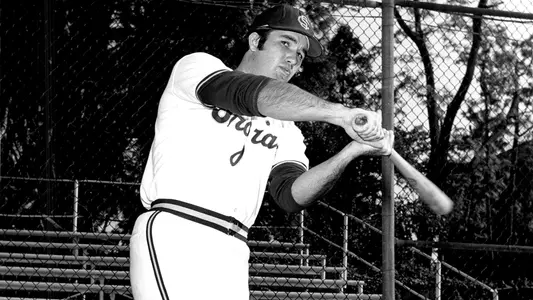 Terry Dedeaux swings a bat in a Trojan uniform in 1973.