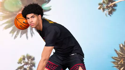 Jacob Cofie of USC men's basketball dribbles ball.