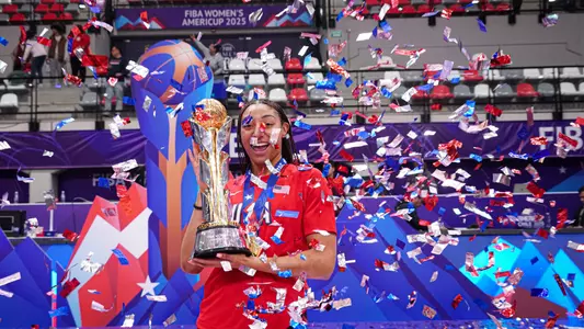 Kennedy Smith holds up the championship trophy won with Team USA at FIBA AmeriCup