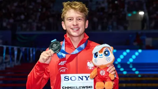 Krzysztof Chmielewski holds up silver medal competing at world Aquatic Championships.