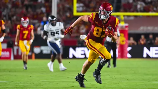 USC tight end Lake McRee maintains his field awareness as he runs toward the end zone after catching a pass.