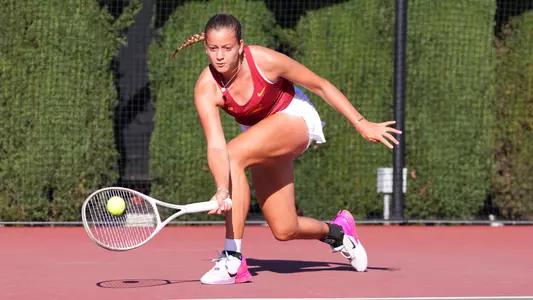 Immi Haddad hits a ball on court.