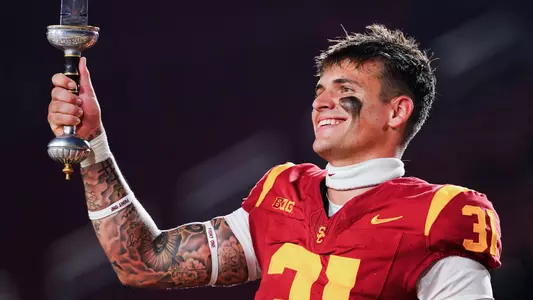 USC long snapper Hank Pepper leads The USC Marching Band after defeating Michigan State