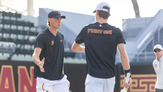 Nathan Trouve high fives a player during play