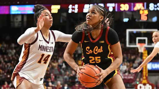 Kara Dunn drives under the basket at Minnesota