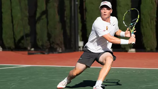 Max Exsted hits a return on the tennis court.